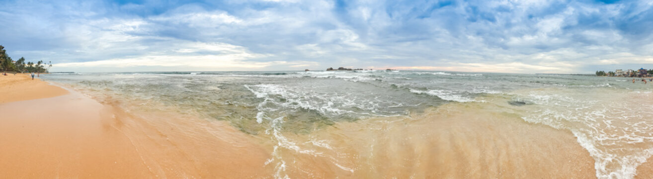 Panoramic image of cloudy sky and calm indian ocean