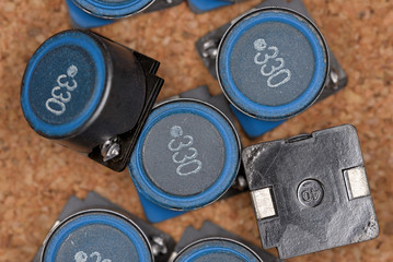 Electronic components, Surface mount inductor (Cork board textured background)