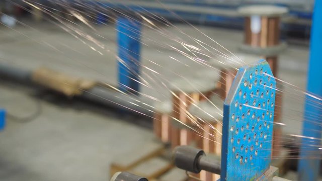 The process of drawing copper wire at a cable production plant. Thin strands of copper wire are woven into a single cable.