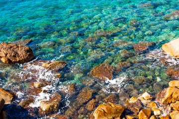Fototapeta na wymiar Clear water and rocks in Costa Paradiso