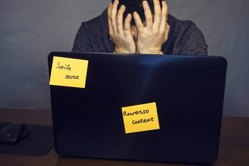 Stressed man near laptop