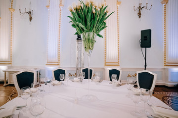 Floral wedding decoration. Wedding table setting decorated with fresh flowers. Wedding floristry. Bouquet with roses, eustoma and eucalyptus leaves.