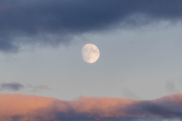 photo of the moon with a thick layer of clouds. moon with clouds