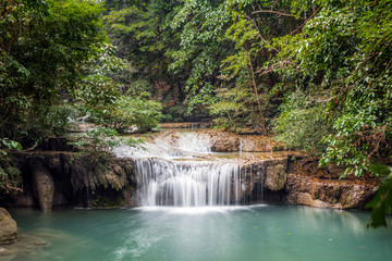 Fototapeta na wymiar Waterfall in national park in jungle, long exposure, in Kanchanaburi, Thailand