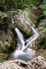 Waterfall in national park in jungle, long exposure, in Kanchanaburi, Thailand