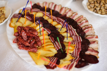 Plate with different kinds of sausages on the holaday table