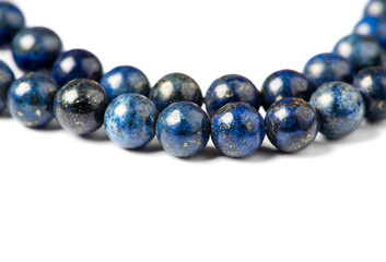Lapis lazuli bracelet on a white background close-up. Lapis lazuli stone beads.