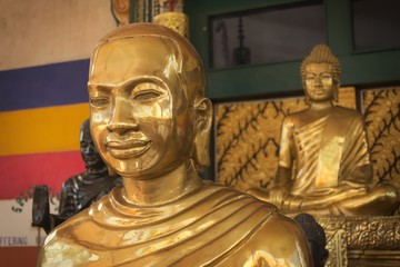 Golden statue of a buddhist monk at a temple in Siem Reap, Cambodia.