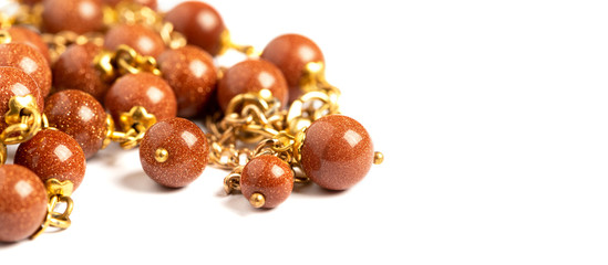 Gold aventurine necklace on a white background close-up, free space for text. Jewelry background.