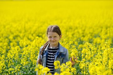 Young girl on a yellow field