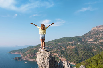 Hiker girl on the mountain top, concept of freedom, victory, active lifestyle, Kabak beach, Oludeniz, Turkey