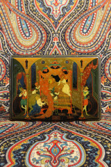 Palekh painting. Casket with traditional national Russian lacquer miniature on papier-mache. Ornamental Pavlovo Posad shawl. Russian style in folk art, handicraft