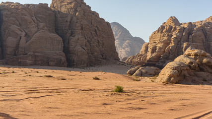 Magic mountain landscapes of Wadi Rum Desert, Jordan. Mountains in lifeless desert resemble Martian craters. Red sand and red rocks. There is place for text.