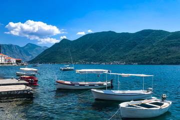 Fototapeta na wymiar small yachts and boats stand on the shore of the city of Perast Kotor Bay Montenegro, Adriatic Sea. Summer 2019