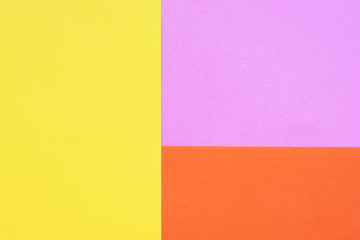 Yellow, orange and lilac colored paper. Geometric empty paper background of three tones for copy space.