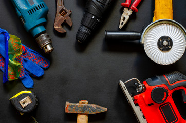 Construction worker tools on a dark background top view.