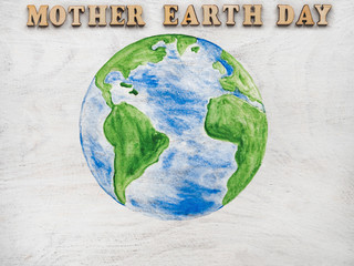 Earth Day. Beautiful greeting card. Isolated background, close-up, view from above, wooden surface. Congratulations for relatives, friends and colleagues