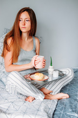 Woman having her breakfast in bed