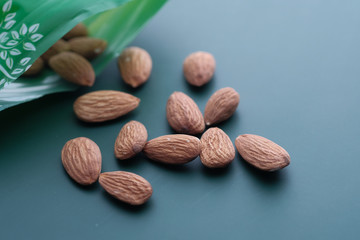 Close up of fresh and raw almond on green background 