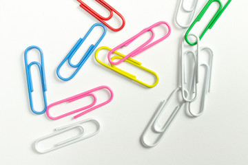 Colorful paper clips isolated on white close-up view.