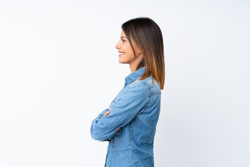 Young woman over isolated white background in lateral position
