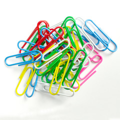 Colorful paper clips isolated on white close-up view.