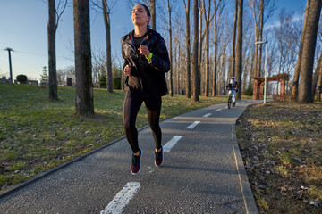 Fototapeta premium Young woman running in the park