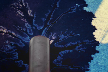 liquid flows from the pipe into the lake and melts the ice. There is a tint. Close-up