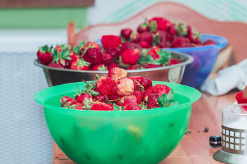 Beautiful fresh strawberries in plastic containers stands on the table