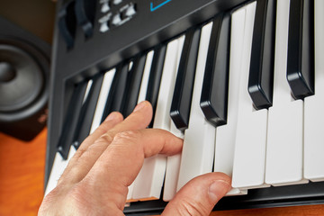 Hands playing piano keyboard or synthesizer
