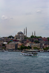 View of Rüstem Paşa Camii mosque in Istanbul, Turkey from the opposite bank on the Golden Horn, ferry boats are in the foreground
