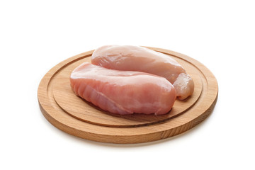 Chilled chicken fillet lying on a cutting board isolated on white background