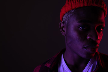 Obraz premium portrait of a stylish handsome american black man in neon light