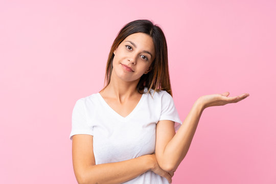 The young woman is looking sad on the pink background. Stock Photo by  ©vova130555@gmail.com 186125244