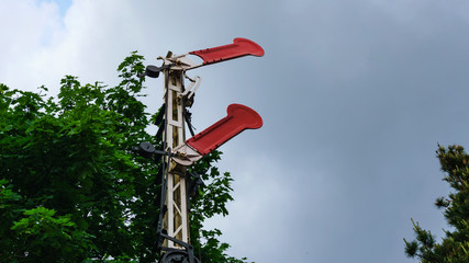 Old preserved semaphore signal on dramatic sky background.