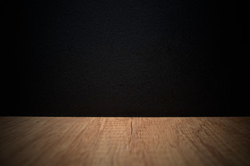 Wooden table on black background