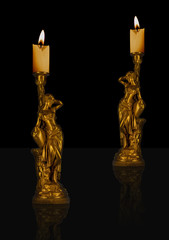 Decorative black and gold sculpture candles with flame. Romantic and relaxable ambiance.