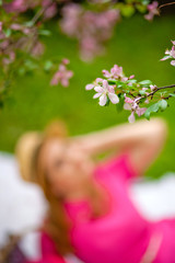 girl in focus on the background of a flowering branch