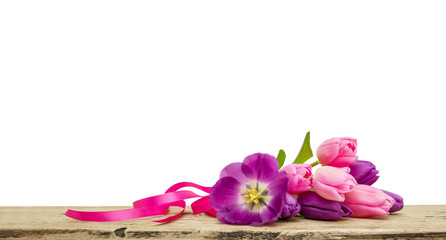Fototapeta na wymiar Pink tulips bouquet with ribbon on wooden Board isolated on white background, copy space