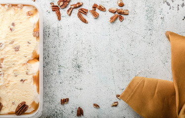 Fototapeta na wymiar ice cream with ground nuts on white concrete table