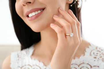 Young bride wearing beautiful engagement ring, closeup
