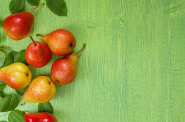 Ripe juicy pear fruit on wooden green background. Summer, harvest concept