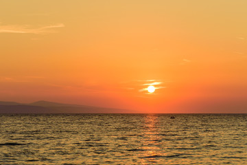 Fototapeta premium Beautiful sunset on the sea. Mediterranean sea at sunset, the town of Brela, Makarska Riviera, Dalmatia region, Croatia. Brela - seaside resort and popular holiday destination in Croatia