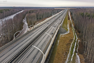 The motorway, which runs between the trees