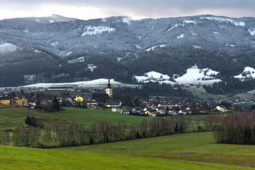 Fototapeta na wymiar Small beautiful austrian village surrounded by mountains in Ennstal, Steiermark, Austria