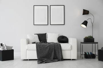 Elegant white sofa in modern living room interior