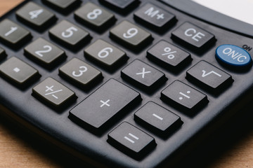 Modern calculator, Business and Finance accounting concept on wooden table