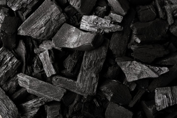 Charcoal for grilling food. Flat lay of coal mineral black stones background. Coal pattern studio background. Black charcoal texture background. Close-up.