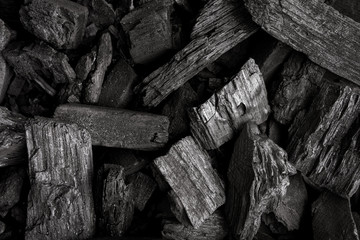 Charcoal for grilling food. Flat lay of coal mineral black stones background. Coal pattern studio...