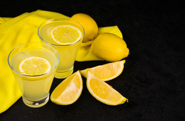  Refreshing lemonade with fresh lemons, black background. Copy space.